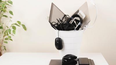 Electrical items like a mouse and headphones in the bin 