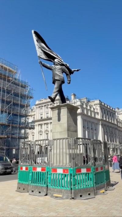 Photo showing Banksy statue in central London.