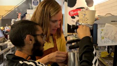 Muriel and Ibraheem at a coffee machine