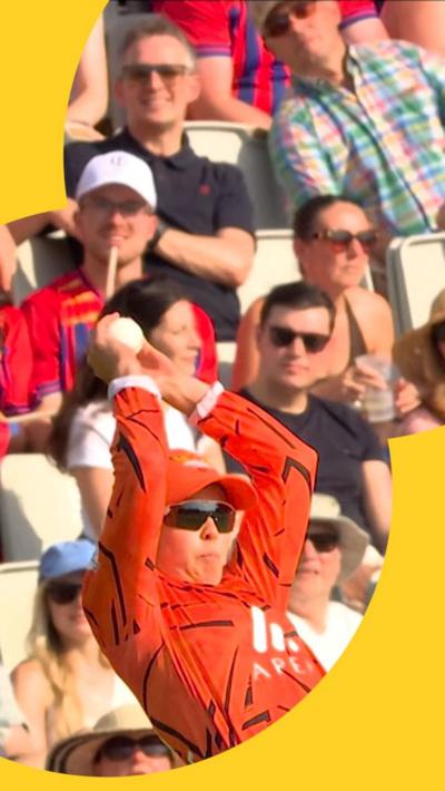 Phoebe Litchfield leaps backwards to make an incredible stop as the crowd behind her watch on