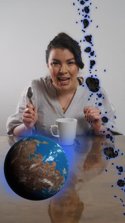 Presenter Cecilia Reed with graphics illustrating planet Earth and an asteroid belt