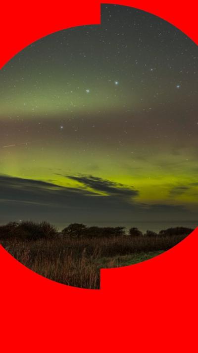 The skies over grassland in Yorkshire glow yellow
