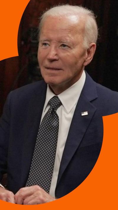 Joe Biden wearing a suit and tie, looking to the left.