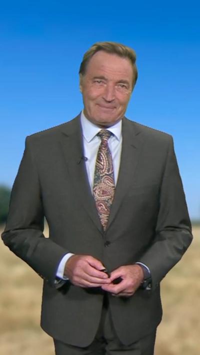 David Braine in a suit on a blurred background.