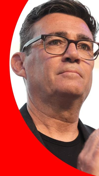 Andy Burnham, who has short dark hair and wears glasses