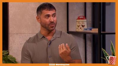Rav Wilding in the Morning Live studio wearing a grey shirt.