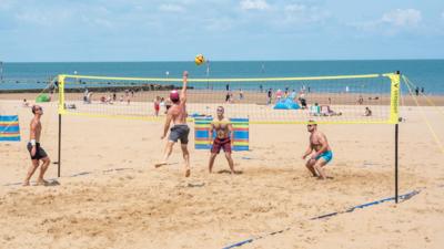 Four people play beach volleyball in Margate, Kent, on 15 June 2025