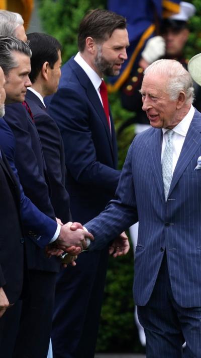 Britain's King Charles III (C) greets US administration officials 