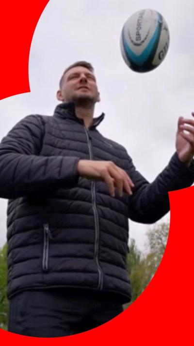 Dan Biggar in a field playing with a rugby ball