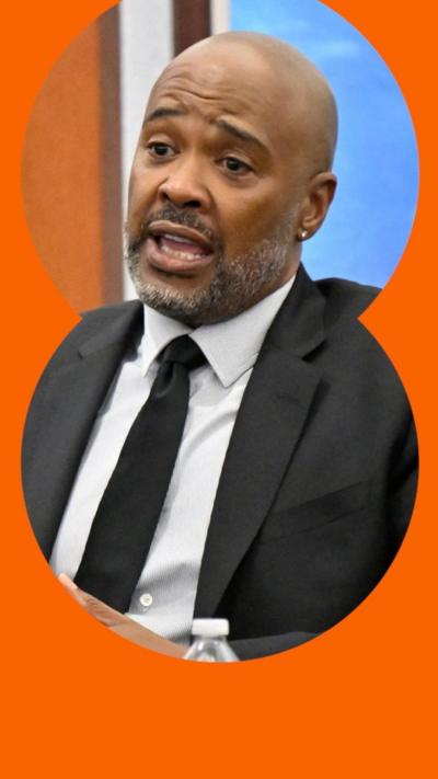 A man in a suit and tie testifies.