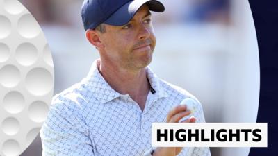Rory McIlroy holding a ball and smiling at the crowd at the Scottish Open.
