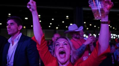 An attendee reacts to early election results at Republican presidential nominee and former U.S. President Donald Trump's election night watch party