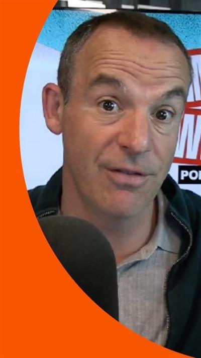 Martin Lewis in front of a microphone 