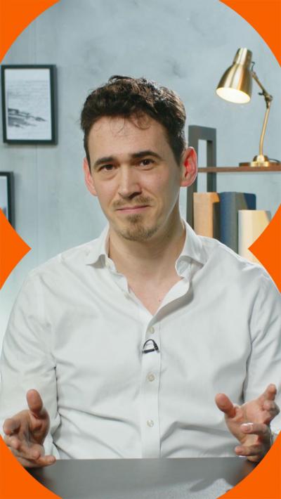 Man wearing white shirt looks at the camera