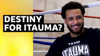 Moses Itauma smiling in interview with boxing ring in background