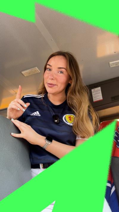 Woman with long hair wearing Scotland top