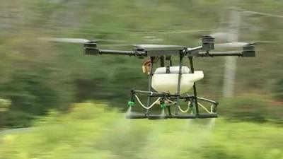 A drone spraying crops with herbicide