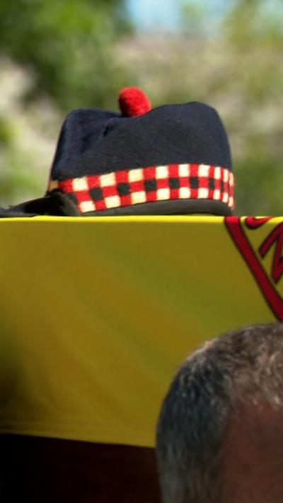 A army beret on top of a coffin