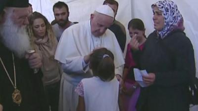 Pope Francis blesses a girl in the Lesbos migrant camp