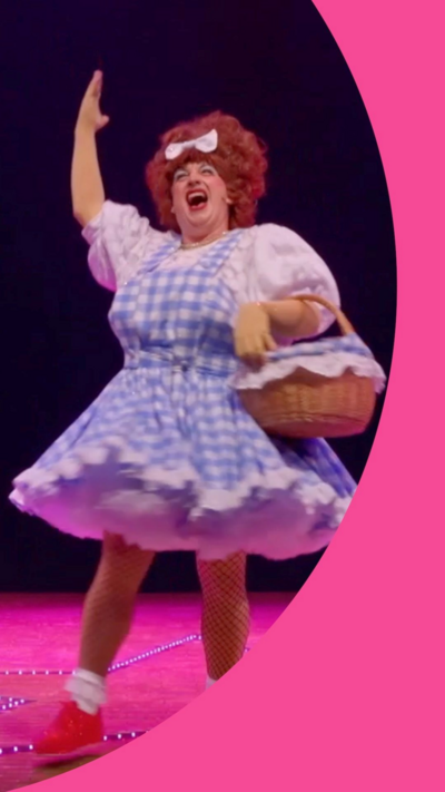Johnny McKnight dressed at a dame on stage during his pantomime show at the Edinburgh Fringe Festival.