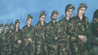 A mural depicts Kosovo fighters