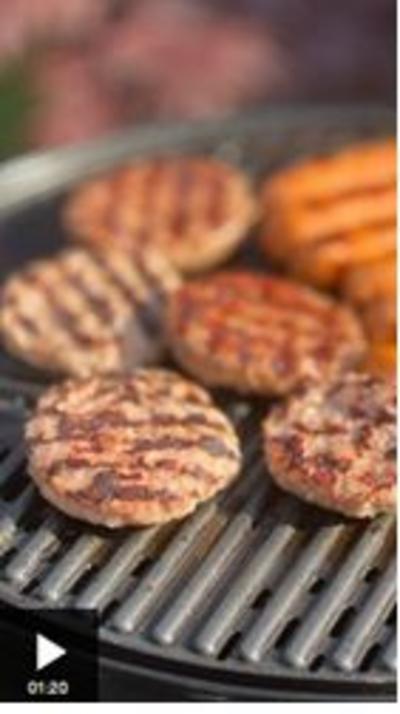 Beef burgers cooking on a home BBQ