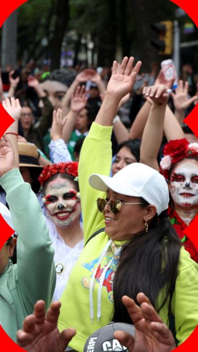 Mexican women in hats and makeup waving
