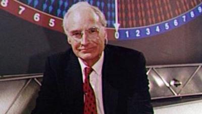 Peter Snow in the Election analysis TV studio. Behind him there is graphic illustrating the swing of votes