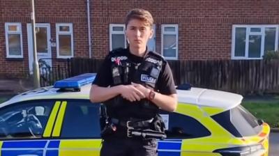 Police officer stood next to car