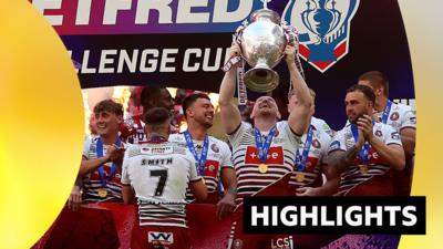 Liam Farrell lifts the Challenge Cup trophy with Wigan Warriors teammates after beating Hull KR in the final.