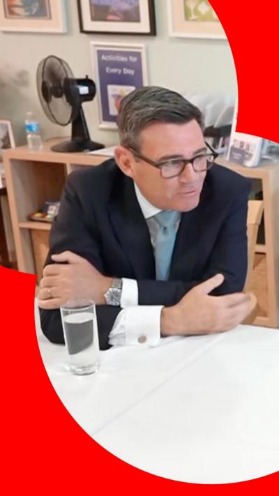 Andy Burnham with his arms folded at a table