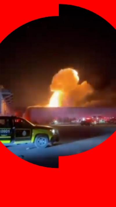 Still of a drone strike in Kuwait with a police car in the foreground.