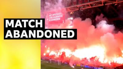 Red fireworks and flares in the stadium stands