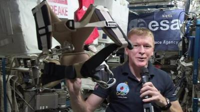 Tim Peake holds harness