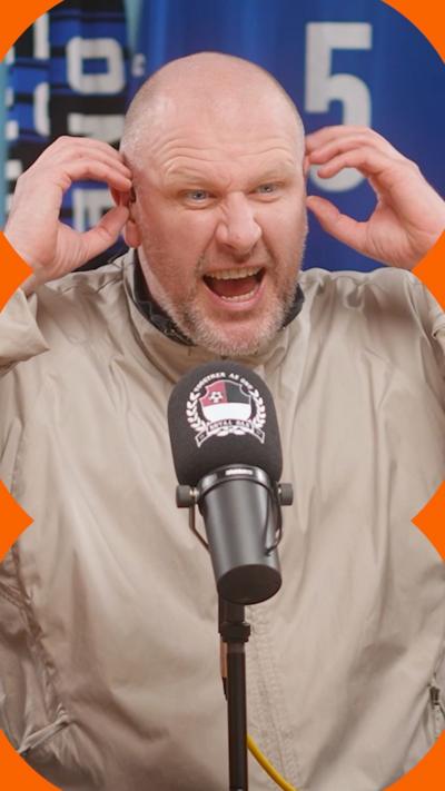 Steve Bracknall holds his hands to his ears with an angry expression on his face