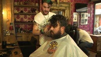 Barber cutting man's hair