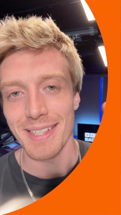 Radio 1 DJ Jack Saunders in the studio, smiling at the camera.