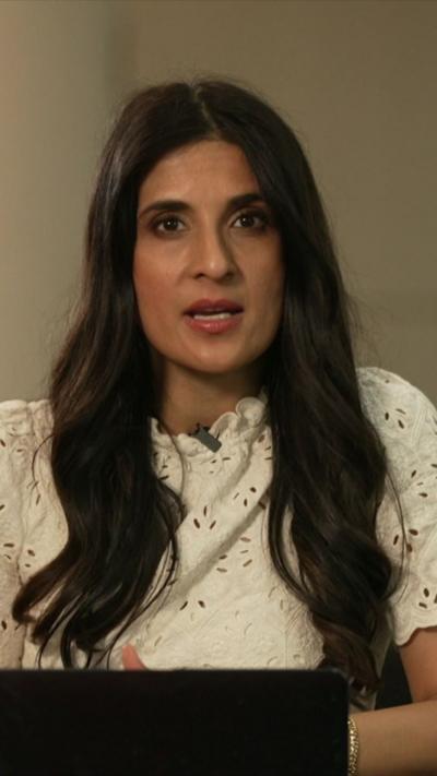 The BBC's Nomia Iqbal, in a cream top, addresses the camera