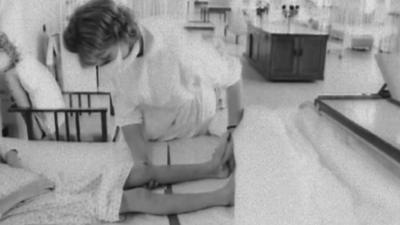 A nurse treating a child with polio