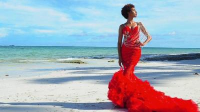 Woman on beach in red wedding dress