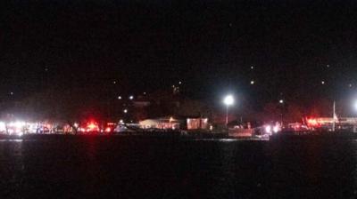 Emergency vehicles by the Potomac River at nighttime