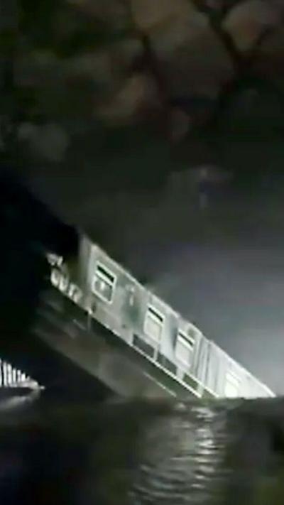 A narrowboat slides over the edge of a canal 