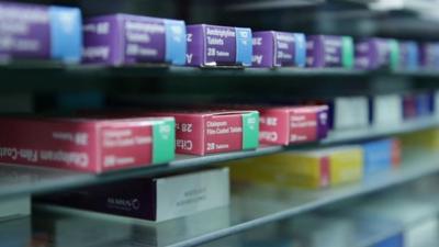 Pharmacy shelf with boxes of medicine