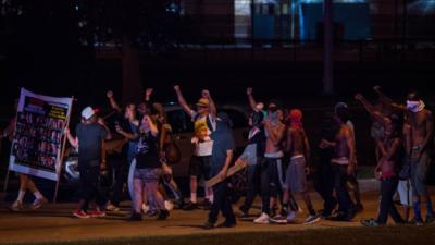 Angry crowds in Milwaukee protesting at night on 14 August.