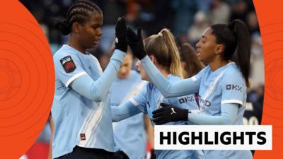 Bunny Shaw and Kerolin high five as they celebrate in blue Man City kit