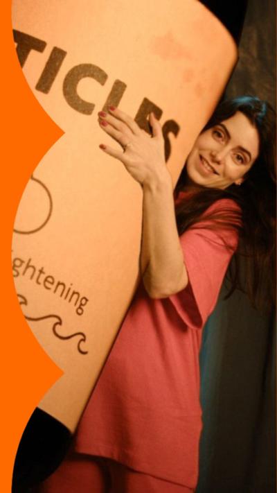 Presenter Josie Peters holding a large bottle labelled particles