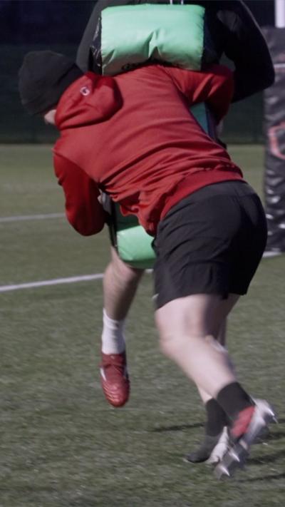 Rugby player tackling another player in a practice game