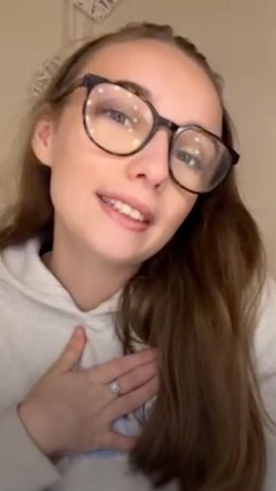 A girl with brown hair and glasses