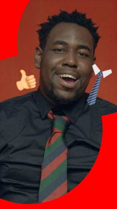 A man wears a black shirt and tie with red, green and blue diagonal stripes. Two emojis are superimposed - a thumbs up and a tie