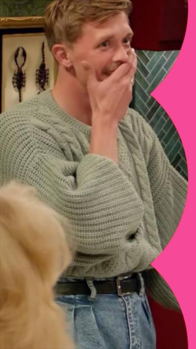 Stephen from the Traitors standing in the kitchen holding his hand over his mouth